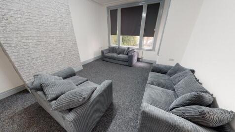 A spacious and modern living room with comforta...