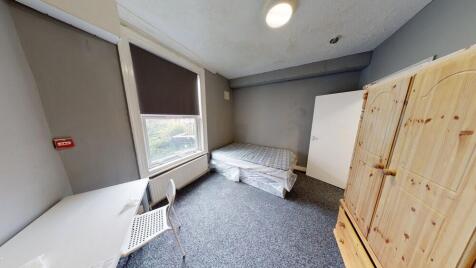 A small and simple room with limited natural li...