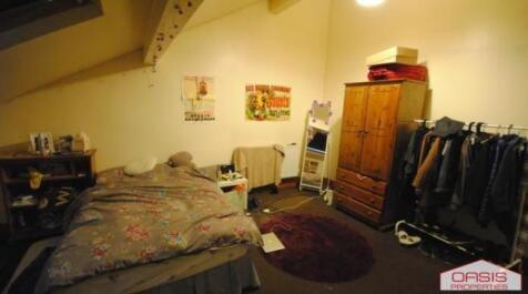 A comfortable bedroom featuring a double bed an...