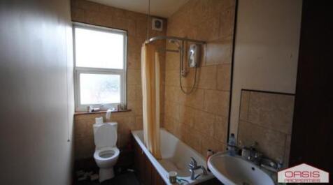 A spacious bathroom featuring a large bathtub, ...