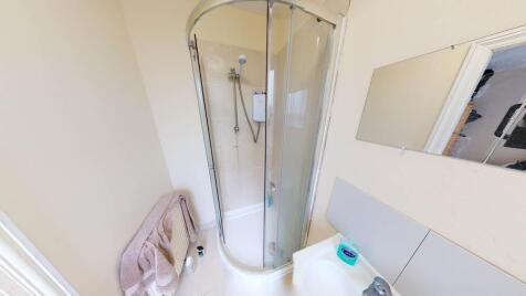 Bright and clean bathroom featuring a shower en...