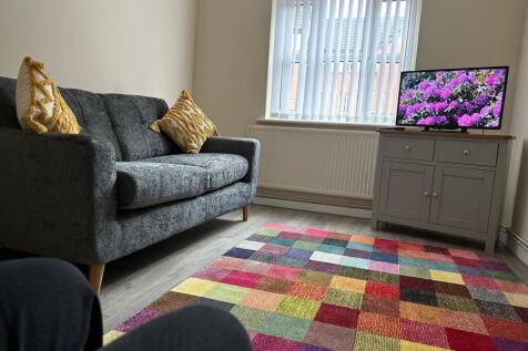 A bright and inviting living room with cozy sea...