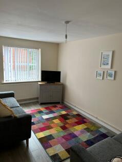 A bright and inviting living room featuring a c...