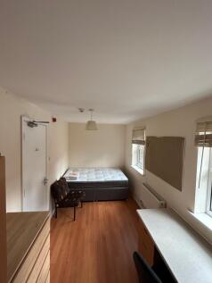 A spacious and inviting double bedroom with nat...