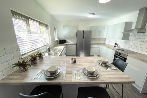 Bright modern kitchen with a large breakfast ba...