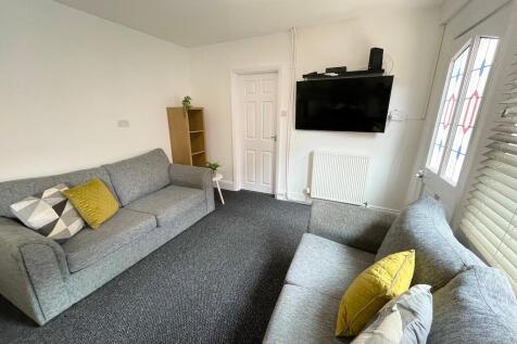 Bright, furnished living room with two comforta...