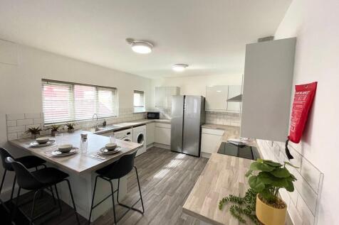Bright modern kitchen with a breakfast bar, int...