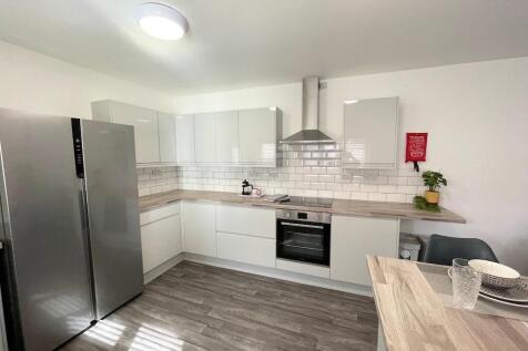 Bright modern kitchen with white gloss cabinets...