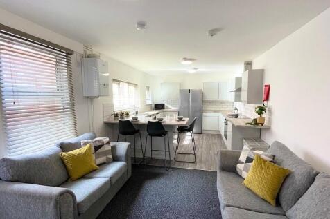 Bright, modern open-plan living area with two c...