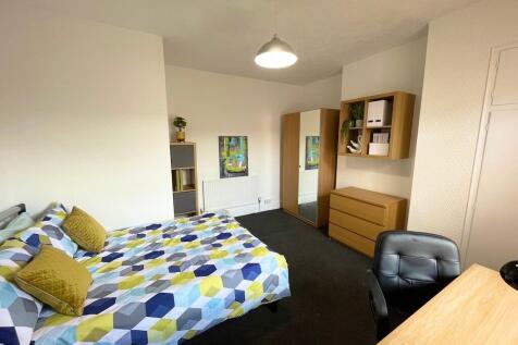 Bright, well-appointed bedroom with a patterned...