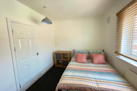 Bright, neatly presented bedroom with a double ...