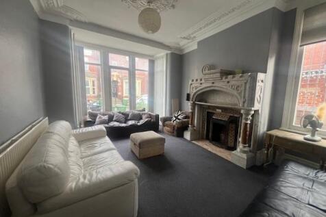 Elegant, high-ceilinged living room with decora...