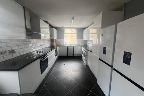 Bright, modern kitchen with sleek white cabinet...