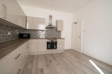 Modern fitted kitchen with grey subway tile spl...