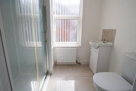 Bright, modern bathroom with a walk-in shower, ...