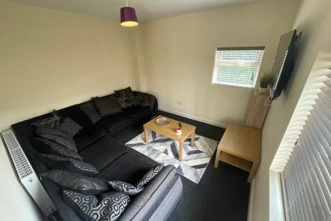 Bright corner living room with a large L-shaped...