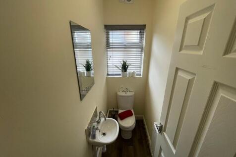 Neat, well-kept WC with a compact basin, contem...