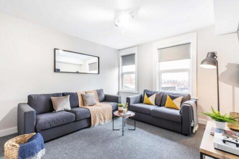 Bright, modern living room with two comfortable...