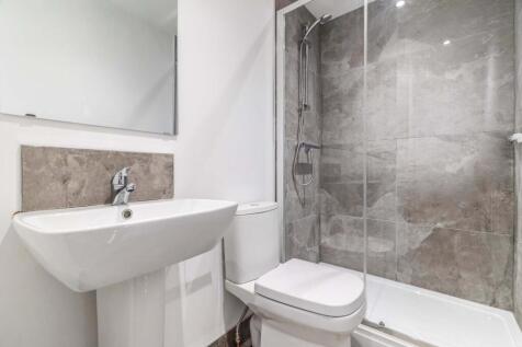Modern ensuite bathroom with a walk-in glass sh...