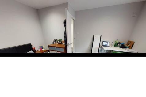 Compact, simply furnished bedroom with neutral ...