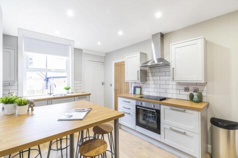 Bright, modern kitchen with a central breakfast...