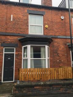 Red-brick terraced house with a bay window, nea...
