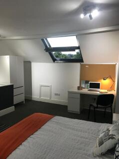 Bright, modern attic double bedroom featuring a...