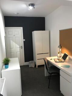 Neat, modern study space with a large white des...