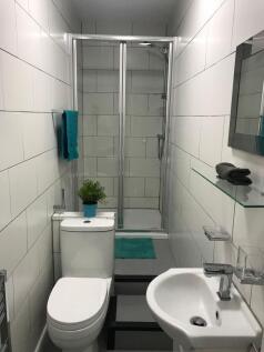 Modern tiled bathroom with a walk-in shower, co...