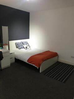 Bright, neatly presented bedroom with a comfort...