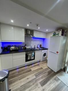 Modern fitted kitchen with glossy white cabinet...