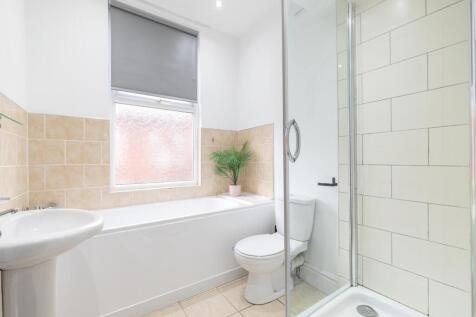 Bright, modern bathroom with a full bath, separ...