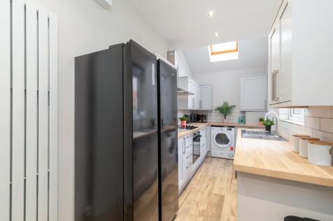 Bright modern kitchen with full-height fridge-f...
