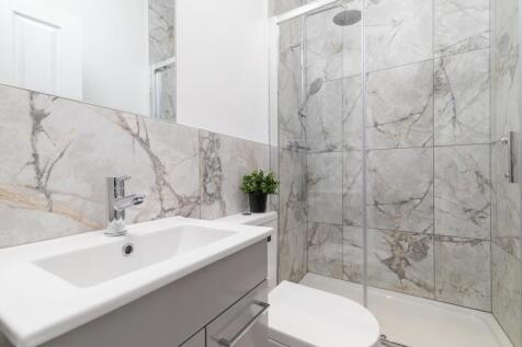 Bright, modern bathroom finished with elegant m...