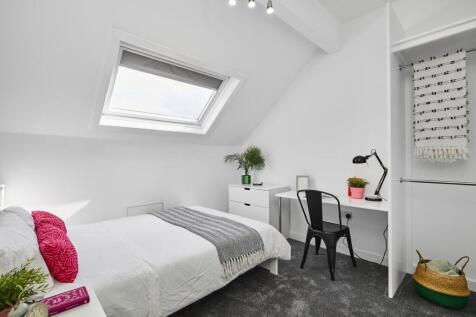Bright, stylish attic double bedroom with a sky...