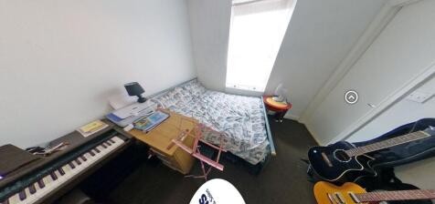 Bright, simply furnished bedroom with a double ...