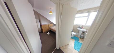 Bright, neutral hallway offering access to a we...