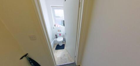 Compact, clean ground-floor WC with tiled floor...