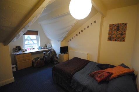 Cozy attic double bedroom with a sloped ceiling...