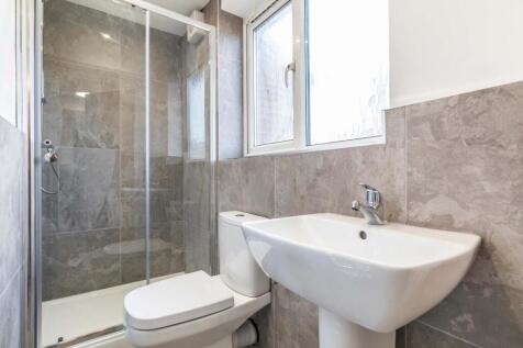 Modern bathroom with a walk-in shower, pedestal...