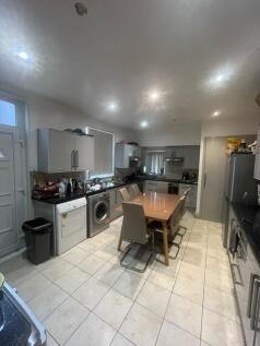 Bright modern eat-in kitchen with a central din...