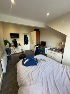 Bright double bedroom with a large bed, built-i...