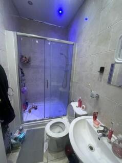 Modern bathroom with walk-in shower and glass s...