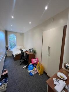 Neat single bedroom with a comfortable bed, bui...