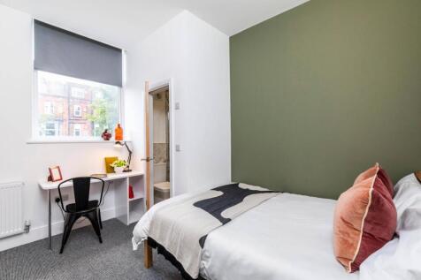Bright, modern bedroom with a comfy double bed,...