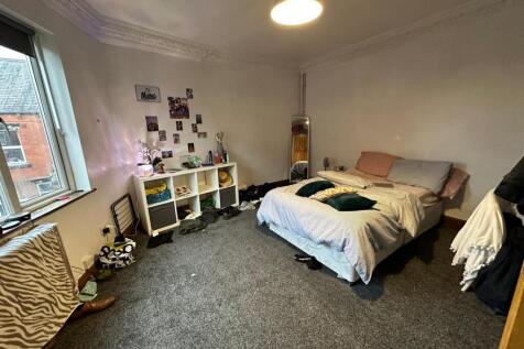 A cozy bedroom with a comfortable double bed, n...