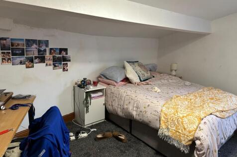 A comfortable bedroom featuring a double bed wi...