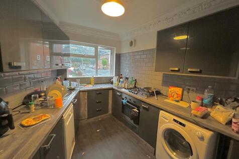 A well-equipped kitchen featuring modern cabine...