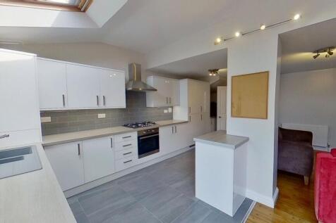 Bright modern kitchen with white gloss cabinets...
