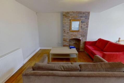Bright, freshly painted living room with wooden...